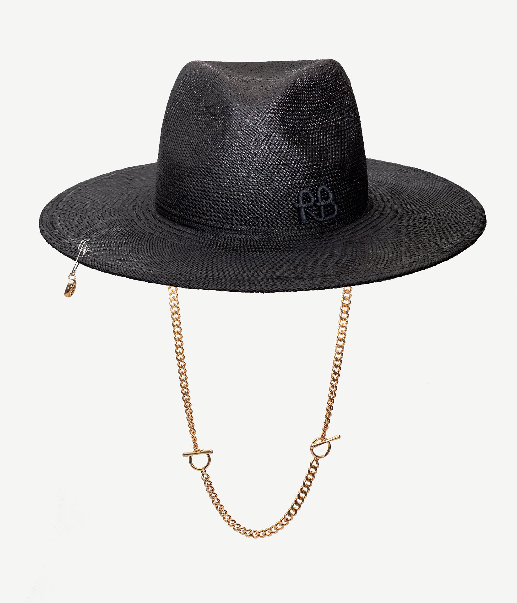 ALLwithoudDIS, Ruslan Baginskiy Straw Fedora with ChainThe fedora is defined by its structured silhouette, featuring a signature center crease and medium-width brim. This version is crafted from tightly woven natural straw in black, designed to hold its shape. Finished with a handcrafted RB monogram, a gold-tone metal chain, and a safety pin adorned with a shell.Handcrafted in Ukraine.