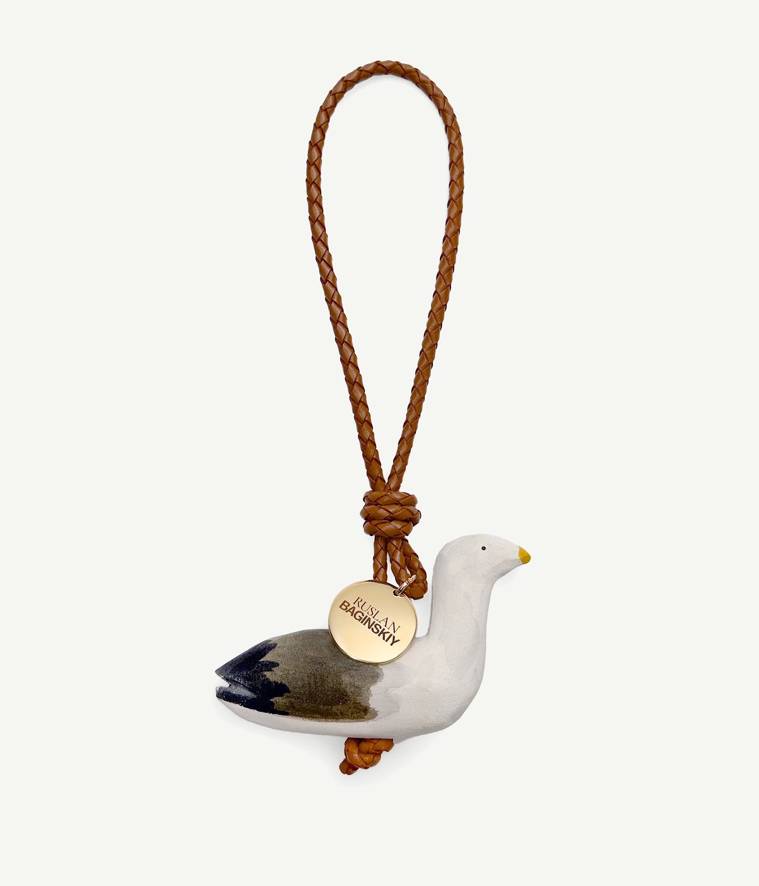 ALLwithoudDIS, RB Bag Charms embody deeply familiar symbols, each carries the emotional legacy of home. Each with its own character — a traveler or a guardian, a dreamer or a quiet observer. Hand-carved from natural wood, delicately painted each bag charm features a leather strap, and finished with an RB metal logo-medallion.The Wild Seagulls — soaring freely over the vast Black Sea, they stand for freedom, openness, and independence. The seagull reminds us of the wide, boundless space where we can breathe deeply and be fully ourselves.