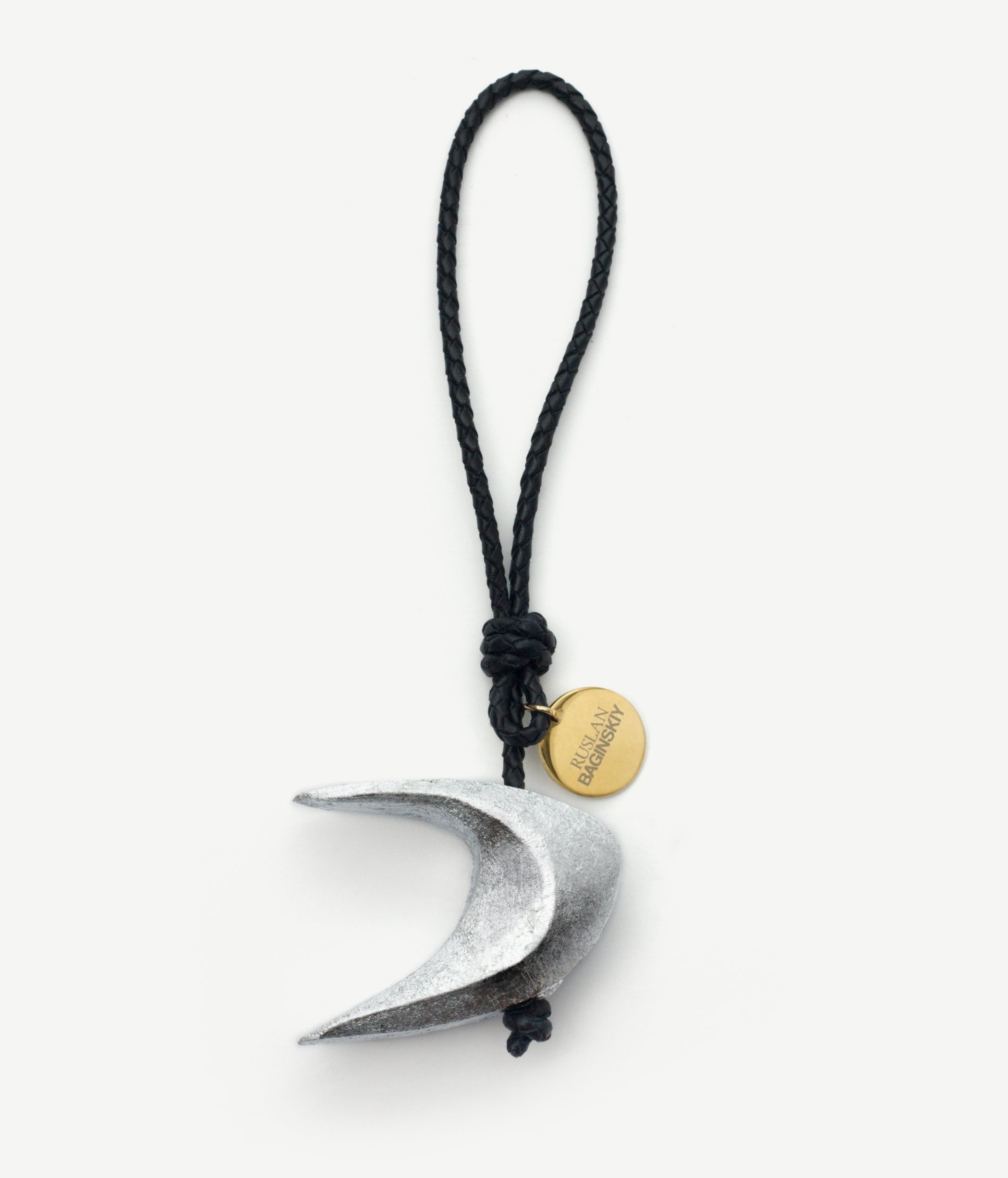 RB Bag Charm, RB Silver CrescentThe second drop of RB Bag Charms — the moon and stars — a symbol of light that we bring to each other in the long winter nights.Inspired by the traditional Ukrainian Christmas star, RB Silver Crescent is hand-carved from natural wood and coated with delicate layers of blue gilding. It evokes the winter night and the gentle glow of the moon, softly illuminating everything around.