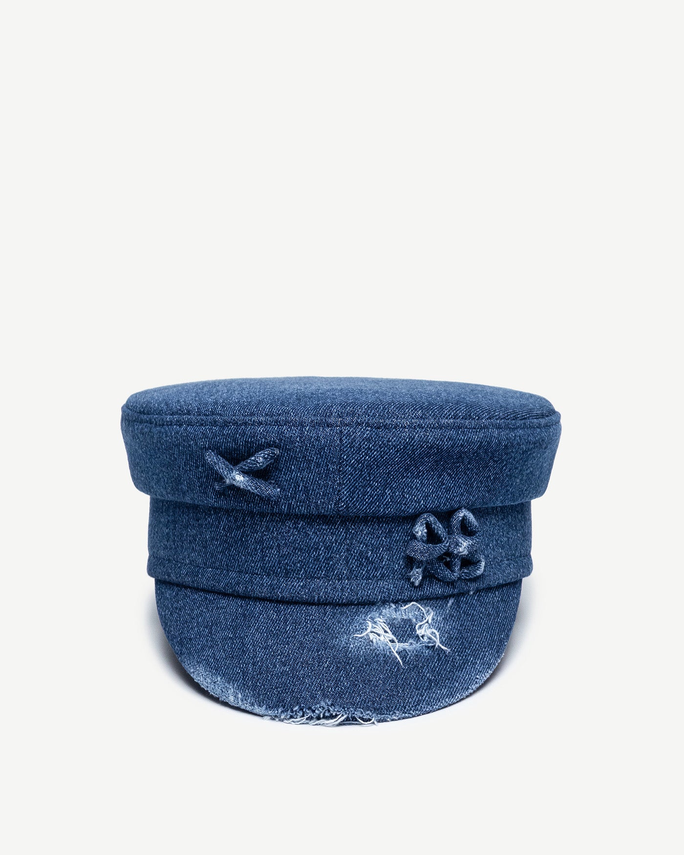 Baker Boy Cap, Ruslan Baginskiy Distressed Denim Baker Boy Cap A brand bestseller, the baker boy bap is crafted from blue denim and features distressed detailing on the brim. Its geometric silhouette adds structure and a striking stylistic accent to any look. The piece is finished with the RB monogram.Handmade in Ukraine.