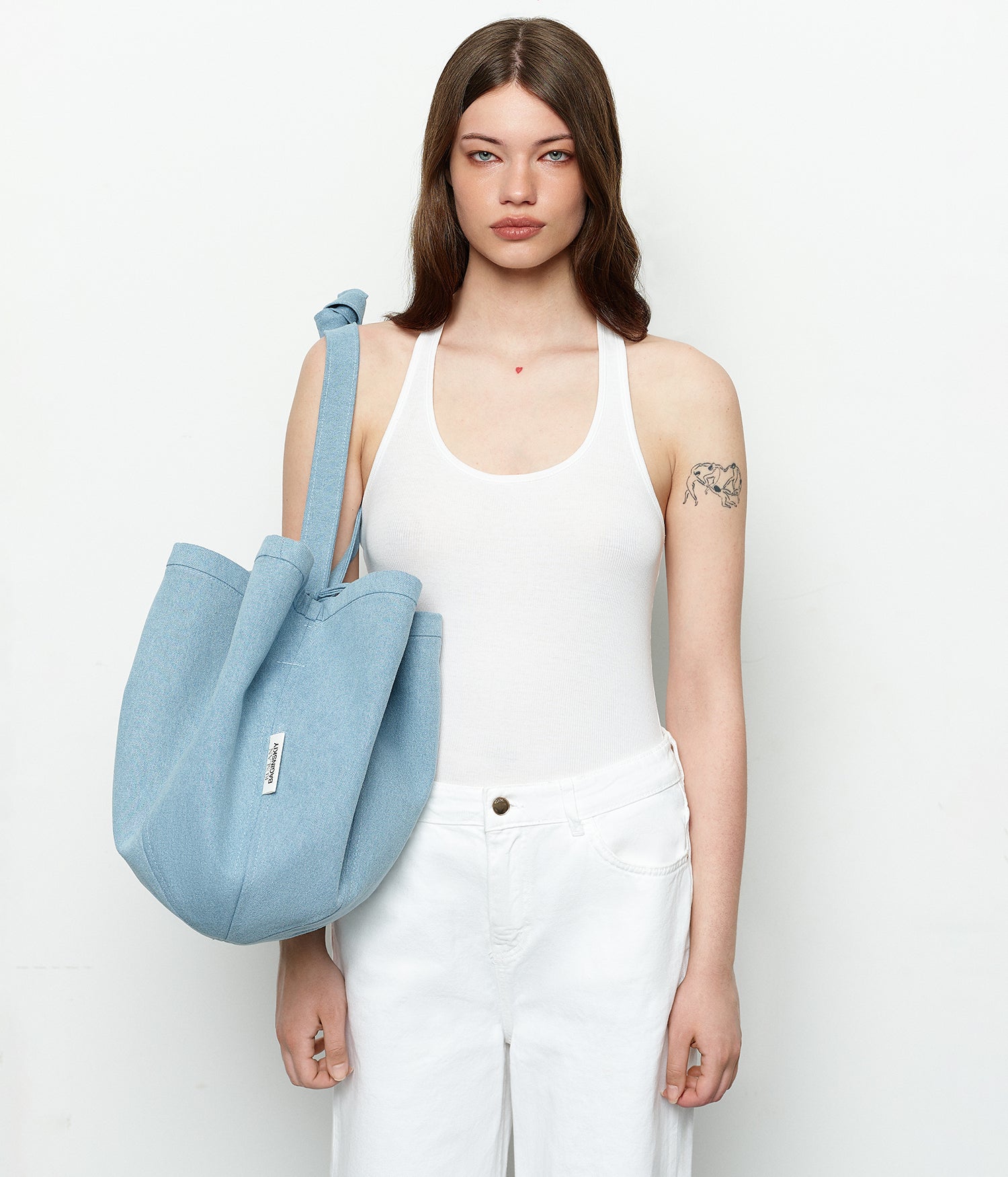 New Arrivals, Ruslan Baginskiy Denim Tote BagA new release — the oversized RB HatBag in light blue denim. This voluminous, practical tote bag resembles RB HatBag but functions solely as a bag.Perfect for city life, travel, or short getaways, it holds all your essentials and becomes a daily companion. Designed for comfortable shoulder or crossbody wear, the sturdy denim maintains its shape, keeping a clear and structured silhouette.Handmade in Ukraine.