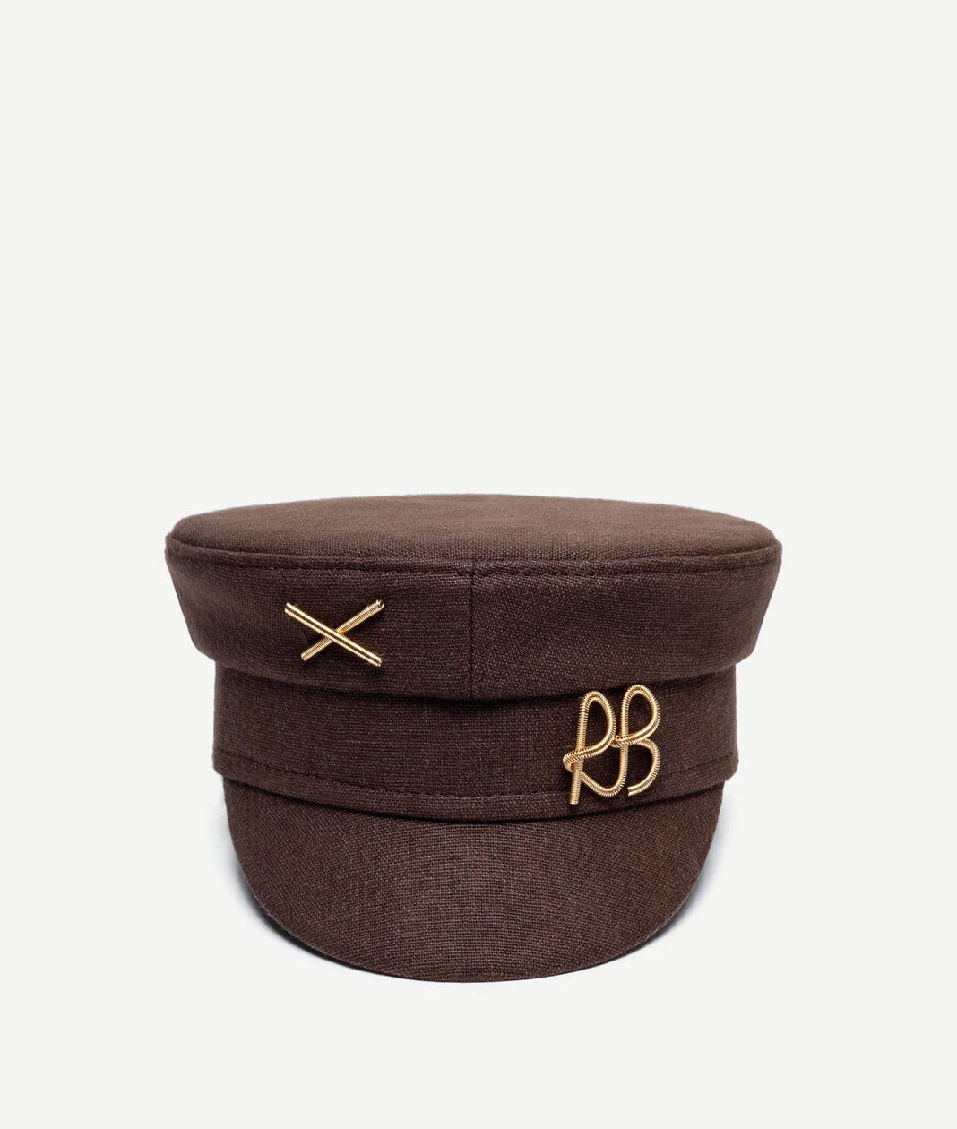 Baker Boy Cap, Ruslan Baginskiy Linen Brown Baker Boy CapA brand bestseller, the baker boy cap is crafted from linen in a brown shade. Its geometric silhouette adds structure and a distinctive stylistic accent to any look. The piece is finished with a gold-tone RB metal logo.Handmade in Ukraine.